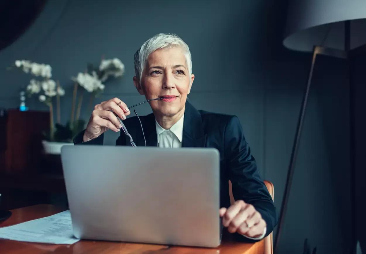 Woman on laptop thinking about the latest payments fraud prevention technology from Kyriba