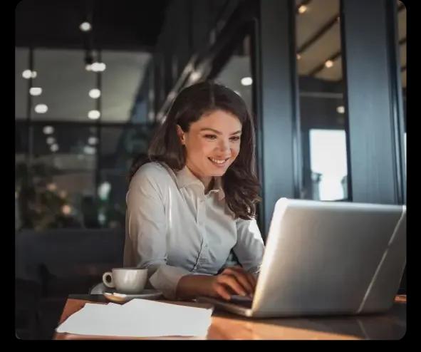 Woman researching Kyriba Treasury on laptop.